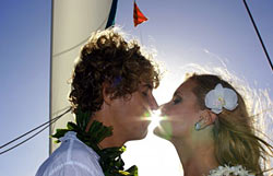Couple kissing with sunset showing through their lips