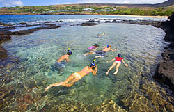 Surrounded by lava rock in a protected pool snorkeling in Lanai